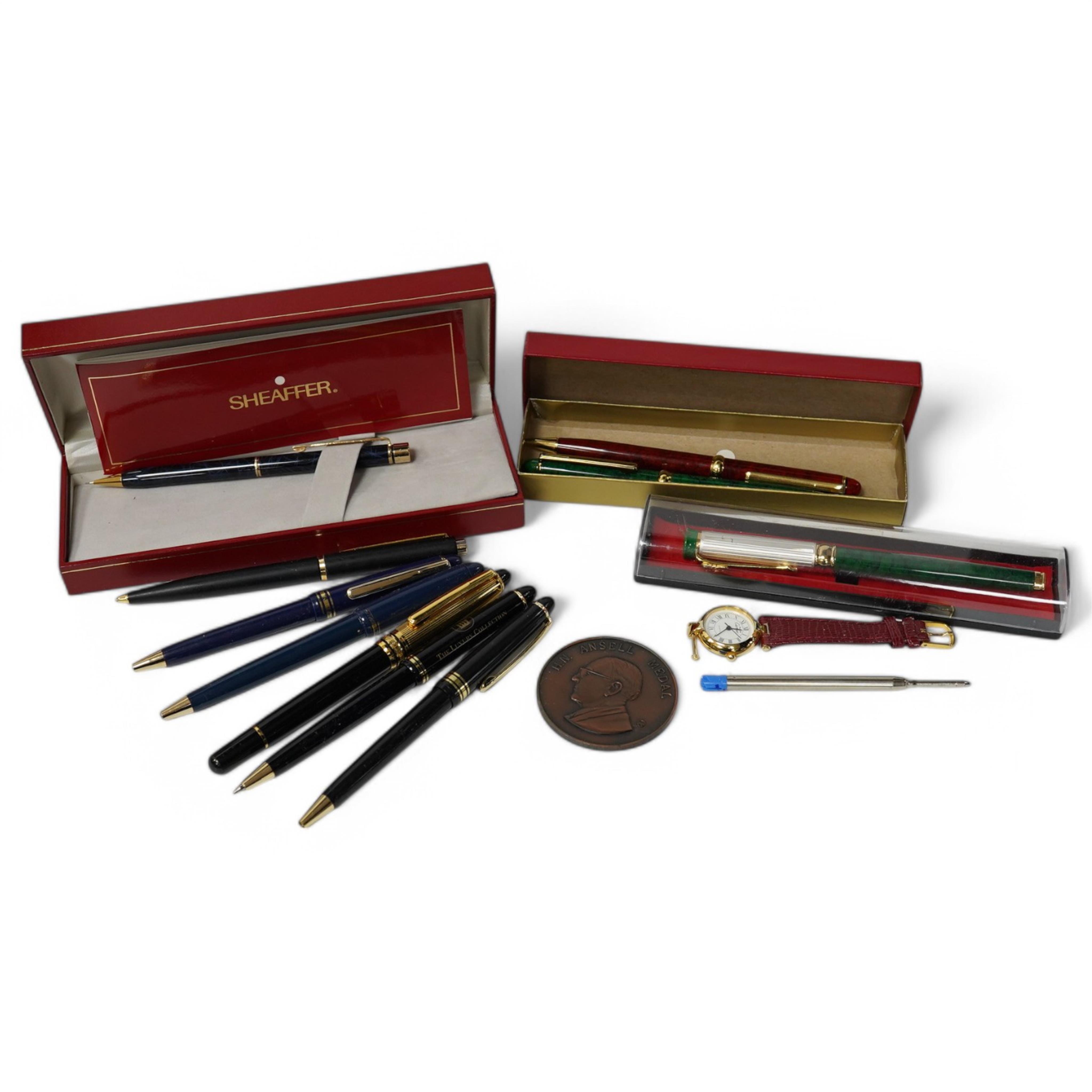 A collection of various pens, a ladies Must de Cartier wrist watch and a H.N. Ansell medal. Condition - varies